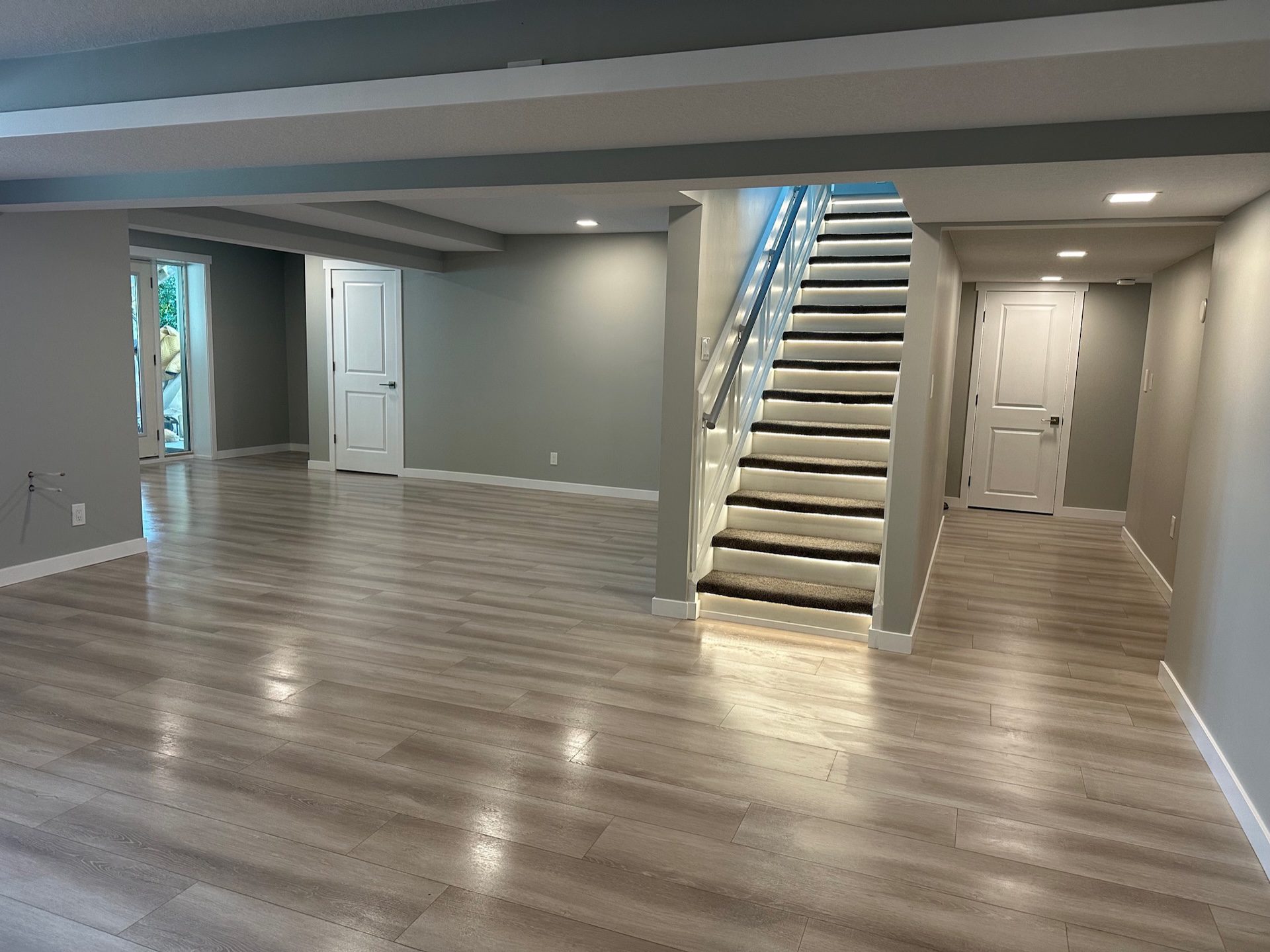 Open Calgary basement development with illuminated staircase